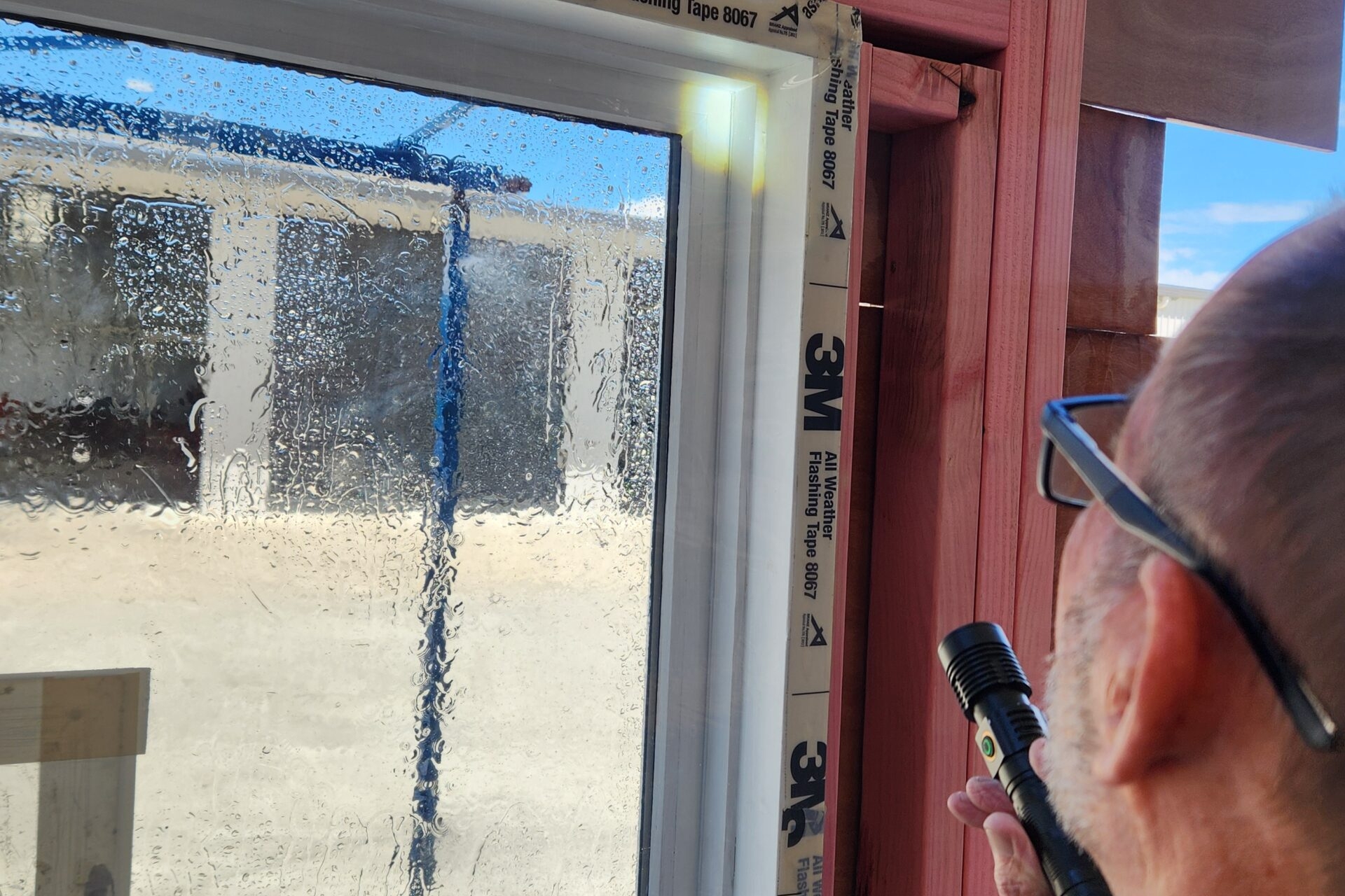 Facade engineer inspecting a window during a WGANZ 502 Field Test for RetroGlaze Network